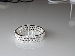 This bracelet has zircon gemstones. The metal is zinc alloy base with silver coating.
