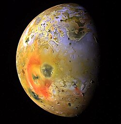 Enhanced-color Galileo image showing a dark spot (just lower-left of center, interrupting the red ring of short-chain sulfur allotropes deposited by Pele) produced by a major eruption at Pillan Patera in 1997