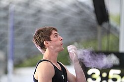 Climber Jan Hojer blows surplus chalk from his hand.