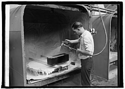 Lacquer being sprayed onto a cabinet