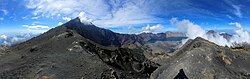 The summit, ash cone, and lake are all visible from this vantage point at 2,600m on the eastern ridge.