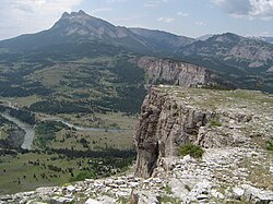 An example of thin-skinned deformation (thrust faulting) of the Sevier Orogeny in Montana. The white Madison Limestone is repeated, with one example in the foreground (that pinches out with distance) and another to the upper right corner and top of the picture.