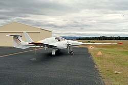 A Diamond DA42 light aircraft, modified for aerial survey with a nose-mounted boom containing a magnetometer at its tip