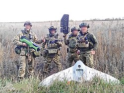Ukrainian National Guard personnel display drone jammers and a downed Russian Grifon 12 drone in 2022.