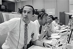 CAPCOM Charles Duke (left), with backup crewmembers Lovell and Haise listening in during Apollo 11's descent