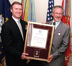 Spielberg receiving a public service award presented by US Secretary of Defense William Cohen, 1999