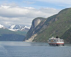 Open-pit mining at Sunnylvsfjorden, Hurtigruten ship passing.