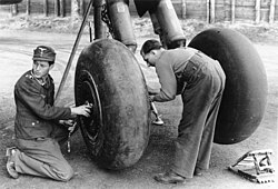 Luftwaffe groundcrew servicing a Heinkel He 177A's main-gear wheels and tires, February 1944