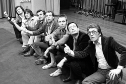 Cast and crew of the first Hitchhiker's Guide radio series. From left: Adams, producer Geoffrey Perkins, actors David Tate, Geoffrey McGivern, Mark Wing-Davey, Simon Jones and Alan Ford.