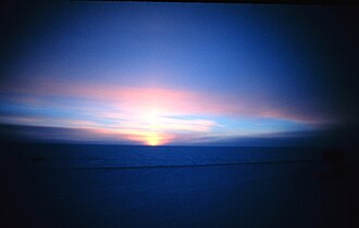 At Earth's poles the Sun appears at the horizon only and all day around equinox, marking the change between the half year long polar night and polar day. The picture shows the South Pole right before March equinox, with the Sun appearing through refraction despite being still below the horizon.