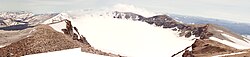 Panorama of Puyehue's crater from near the summit. In the background, black lavas from the 1960 Cordón Caulle eruption.