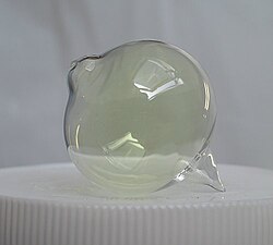 Gaseous chlorine stored inside a spherical container.