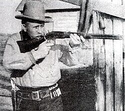 Bill Tilghman posing with his Winchester rifle in a scene from the 1915 film The Passing of the Oklahoma Outlaws