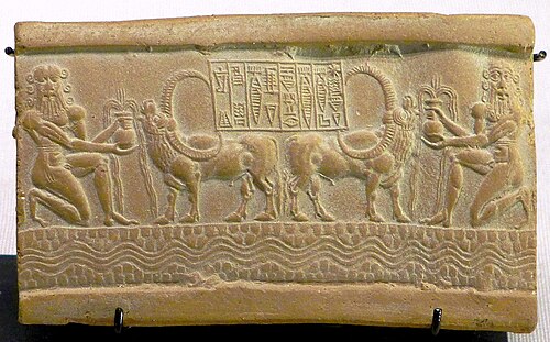 Impression of a cylinder seal of the time of Akkadian King Sharkalisharri (c. 2200 BC), with central inscription: "The Divine Sharkalisharri Prince of Akkad, Ibni-Sharrum the Scribe his servant". The long-horned buffalo is thought to have come from the Indus Valley, and testifies to exchanges with Meluhha (the Indus Valley civilization) in a case of Indus-Mesopotamia relations. Circa 2217–2193 BC. Louvre Museum.[95][96][97]