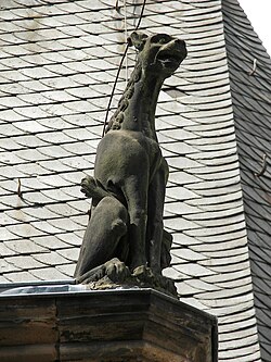 A figure depicting the term domini canes ('hounds of the lord') since the Inquisition in the 13th century,[b][37][clarification needed] on a corner of a former Dominican monastery (before the Reformation), Old University, Marburg, Germany