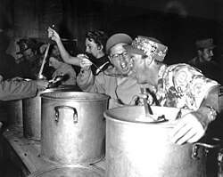 Rooney feeds the troops for the USO in 1952.