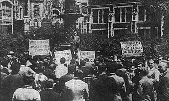 Simon Gerson, a student expelled for opposing military training at the school, addresses a demonstration under the campus flagpole, June 15, 1928