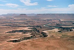At Canyonlands National Park in Utah, sheets of water flow across the plains and enter the canyons. As they do so, the top edge of the canyon erodes back into the plain above, both lengthening and widening the canyon. Widening of a canyon by erosion inside the canyon below the top, because of the flow of the stream inside the canyon, is not called headward erosion.