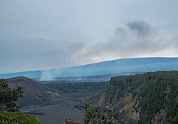 View from the edge of Kilauea Iki: across Kaluapele, Halemaʻumaʻu is emitting fume on the left side of Kaluapele, while Mauna Loa towers above in the background (March 2013)