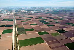 Irrigation of agricultural fields in Andalusia, Spain. Irrigation canal on the left.