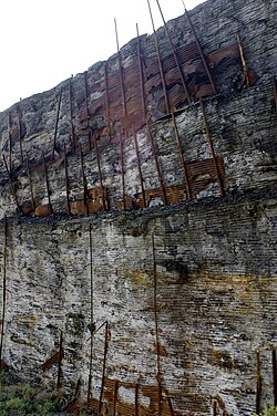 A path through a slag heap in Clarkdale, Arizona, showing the striations from the rusting corrugated sheets retaining it