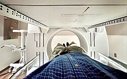 A patient lies inside a nuclear medicine machine at a hospital