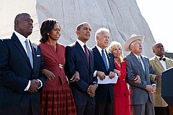 U.S. President Barack Obama, Vice President Joe Biden and their wives link arms and sing "We Shall Overcome" at the dedication of the Martin Luther King Jr. Memorial in 2011.