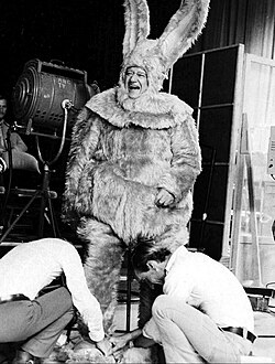 John Wayne being fitted for a giant bunny costume, 1972