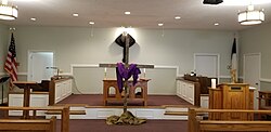 Altar and cross veiled in a Methodist church on Maundy Thursday in preparation for Good Friday