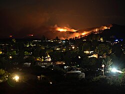 Flames and plumes of smoke from the Tiger Fire can be seen from Spring Valley, Arizona overnight on July 6, 2021