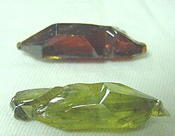 The red and green colors of these synthetic ZnO crystals result from different concentrations of oxygen vacancies.[55]