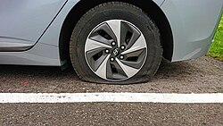 A flat tire on a passenger car