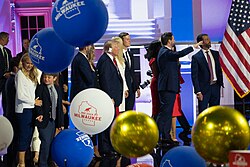 Trump, JD Vance, and their families on stage at the 2024 Republican National Convention. Trump is wearing a bandage on his ear, which was hurt during an assassination attempt on him earlier that month.[272][273]