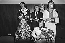 Brotherhood of Man, Hiller, and Ainsworth just after winning, with the songwriters holding their medals.