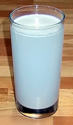 A suspension of flour mixed in a glass of water, showing the Tyndall effect