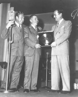 First gold record award for "Chattanooga Choo Choo" presented to Miller by W. Wallace Early of RCA Victor with announcer Paul Douglas on far left, February 10, 1942