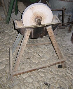 A grinding wheel with a reservoir to hold water as a lubricant and coolant.
