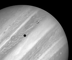 A picture of Jupiter and its moon Io taken by Hubble. The black spot is Io's shadow.