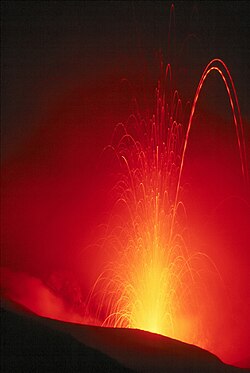 Eruption of Stromboli (Italy), approximately 100 m (300 ft) vertically. Exposure of several seconds. The dashed trajectories are the result of lava pieces with a bright hot side and a cool dark side rotating in mid-air.