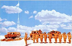 Argentinian soldiers saluting the flag after erecting the pole in 1965