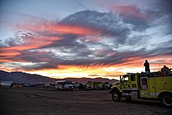 U.S. Bureau of Land Management wildland fire engines at the Numbers Fire Incident Command Post during sunset.