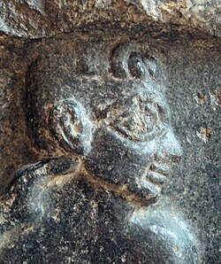 Portrait of a Sumerian prisoner on a victory stele of Sargon of Akkad, c. 2300 BC.[38] The hairstyle of the prisoners (curly hair on top and short hair on the sides) is characteristic of Sumerians, as also seen on the Standard of Ur.[39] Louvre Museum.