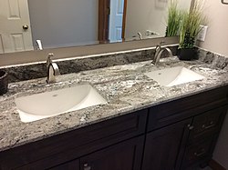 A modern, granite bathroom countertop with sinks, USA