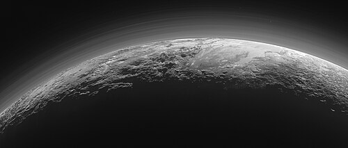 A panoramic view of Pluto's icy mountains and flat ice plains. Imaged by New Horizons, 15 minutes after its closest approach to Pluto. Distinct haze layers in Pluto's atmosphere can be seen backlit by the Sun.
