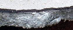 As shown in this cross-section, many older roadways are smoothed by applying a thin layer of asphalt concrete to the existing Portland cement concrete, creating a composite pavement.