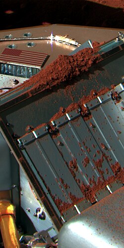 NASA's Phoenix Mars Lander analyzing a soil sample from the "Rosy Red" trench with the TEGA mass spectrometer
