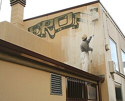 Self-referential graffiti. The painter drawn on a wall erases his own graffiti, and may be erased himself by the next facade cleaner.