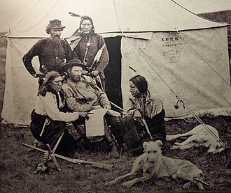 Pictured above, to the far left, kneeling is Bloody Knife next to George Custer, seated in the center[6]