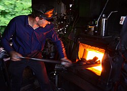 A fireman working on a German Class 52 steam locomotive