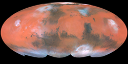 Mollweide projection of albedo features on Mars from Hubble Space Telescope. Bright ochre areas in left, center, and right are Tharsis, Arabia, and Elysium, respectively. The dark region at top center left is Acidalia Planitia. Syrtis Major is the dark area projecting upward in the center right. Note orographic clouds over Olympus and Elysium Montes (left and right, respectively).